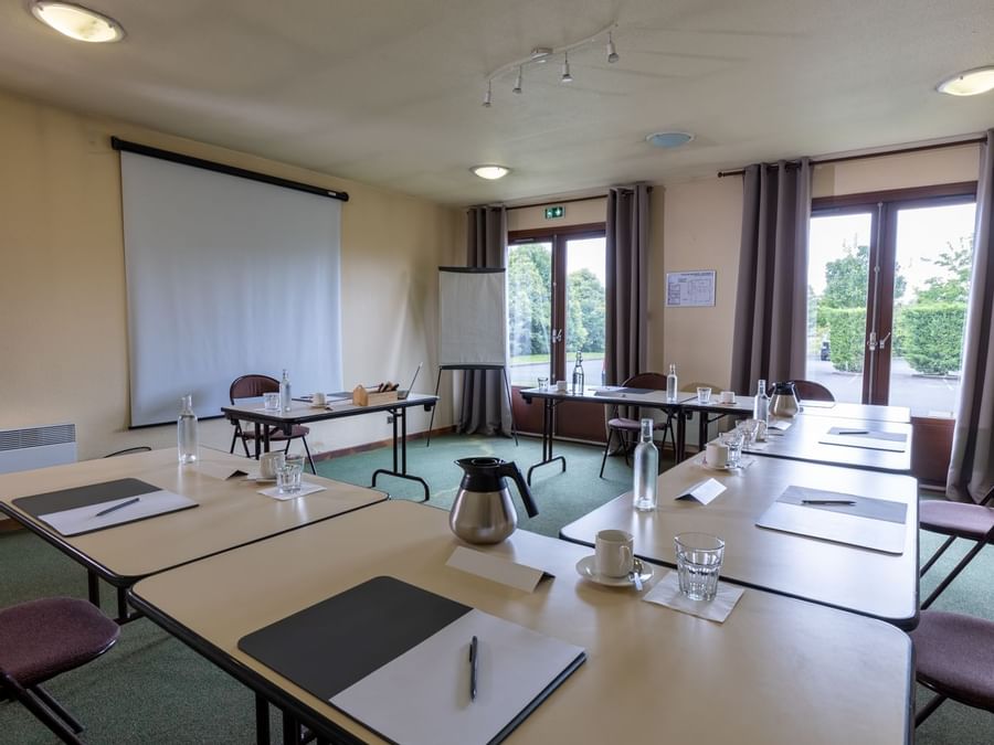 conference room with projector screen at hotel du lac