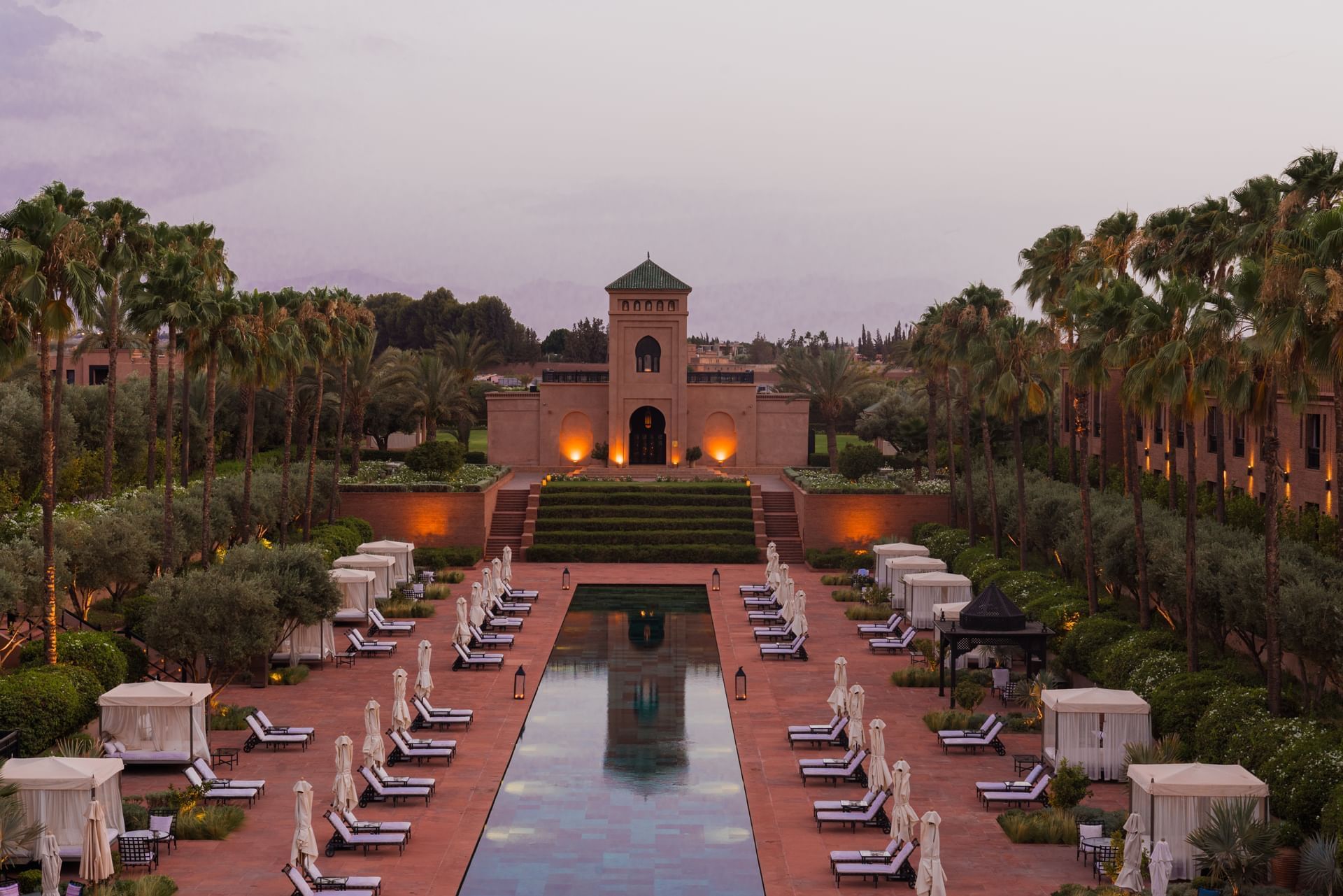 Outdoor pool area with sun loungers at the evening Selman Marrakech