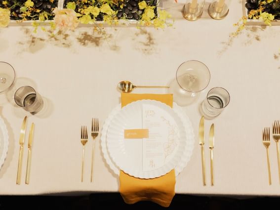 Close-up of culinary arranged on a dining table with floral deco at Melbourne Hotel Perth