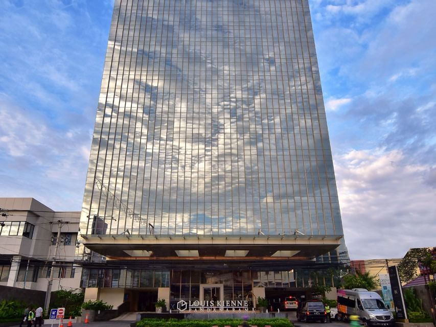 Low angle exterior view of LK Pandanaran Hotel & Serviced Apartments with an underground carpark