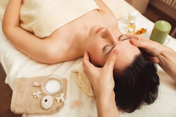 Woman having a head massage in a spa at The Abbey Inn