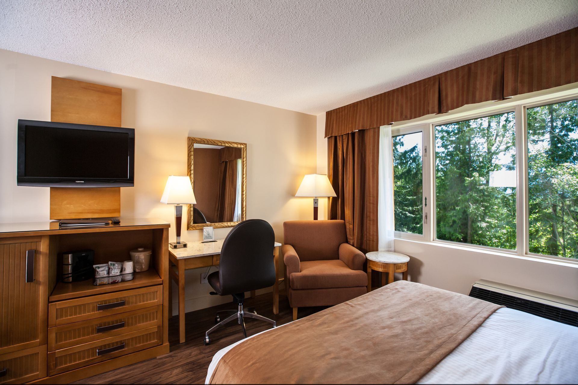 Bed in hotel room with scenic view of greenery