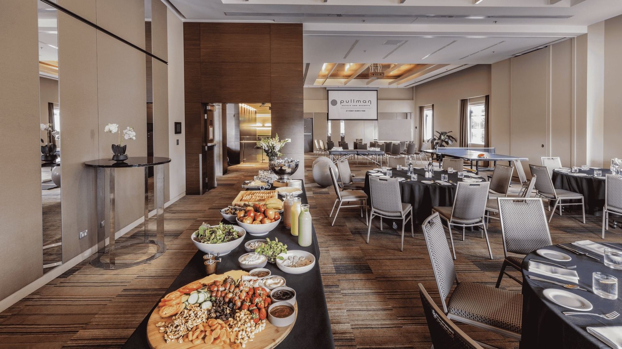 Dining tables & breakfast corner arranged in Nexus Room at Sydney Olympic Park