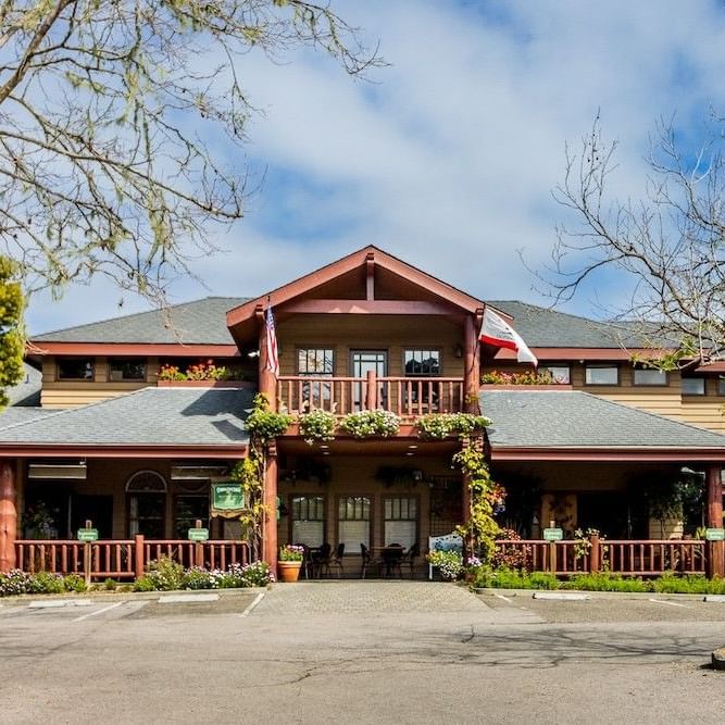 Ground-level exterior view of Cambria Pines Lodge buildings and gardens in Cambria, California