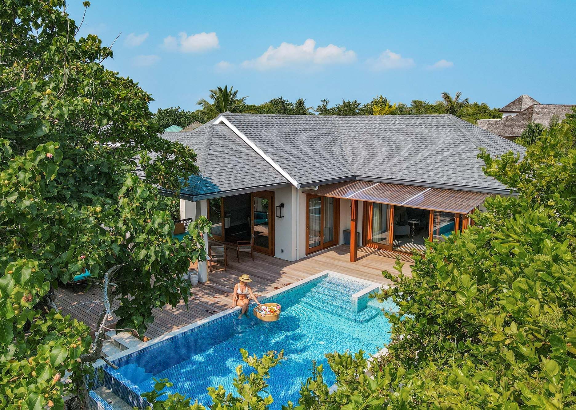 A lady relaxing by the pool at The Signature Collection