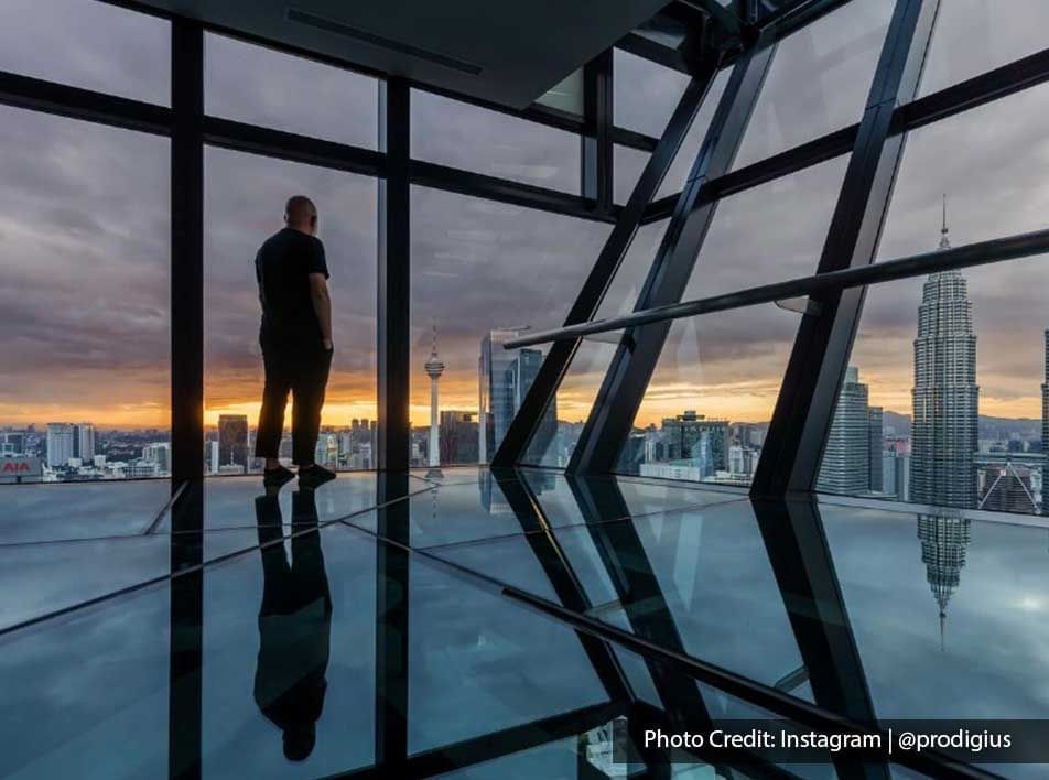 The man enjoying the city view from the sky deck of Imperial Lexis Kuala Lumpur at sunset.