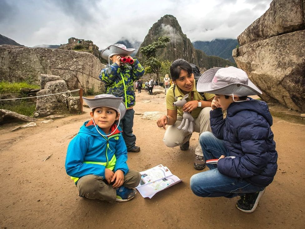 Three kids exploring with a tour guide near Hotel Sumaq
