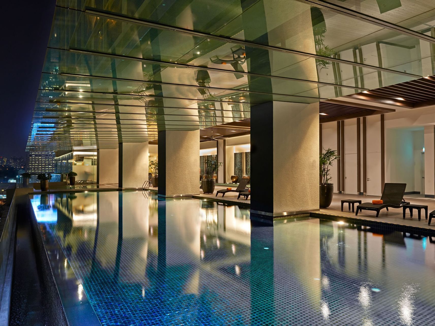 Indoor infinity pool at VE Hotel & Residence at night