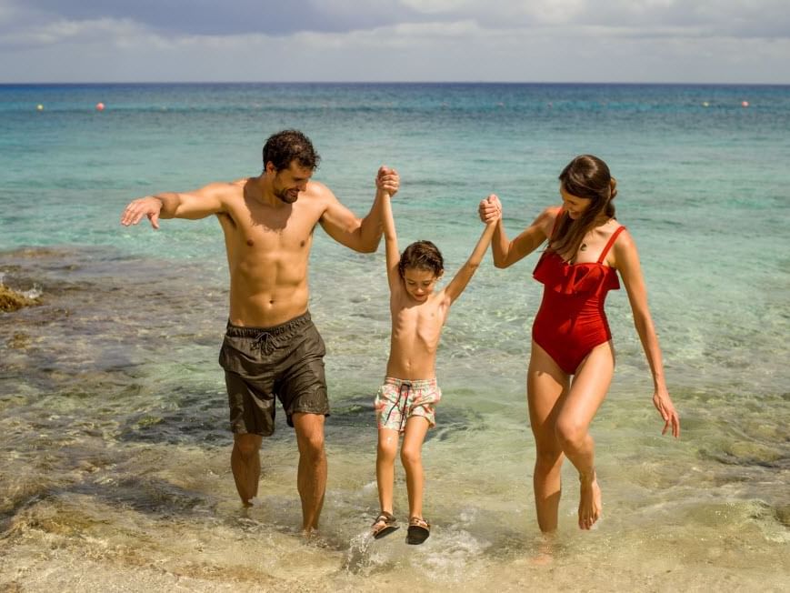 A boy with his parents at the sea near Grand Fiesta Americana