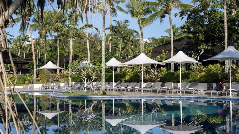 Pool and terrace beach area with loungers and umbrellas at Warwick Le Lagon - Vanuatu, Efate.