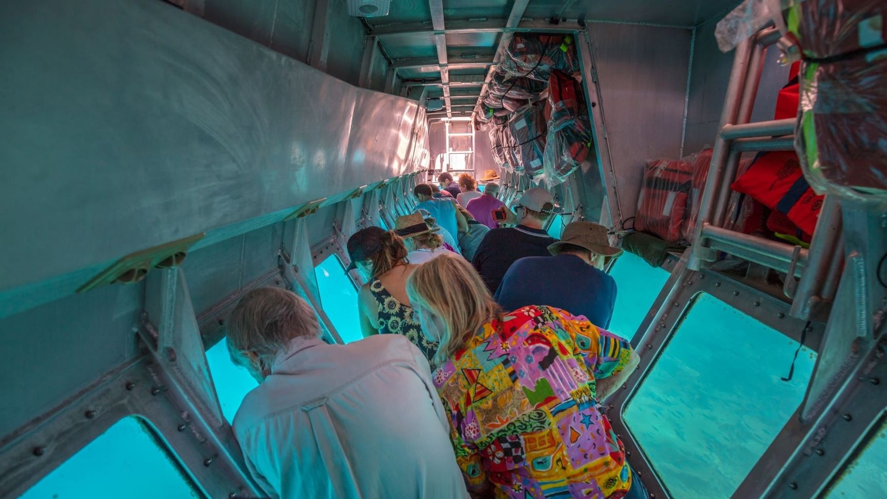 People in a glass-bottom boat tour near Heron Island Resort