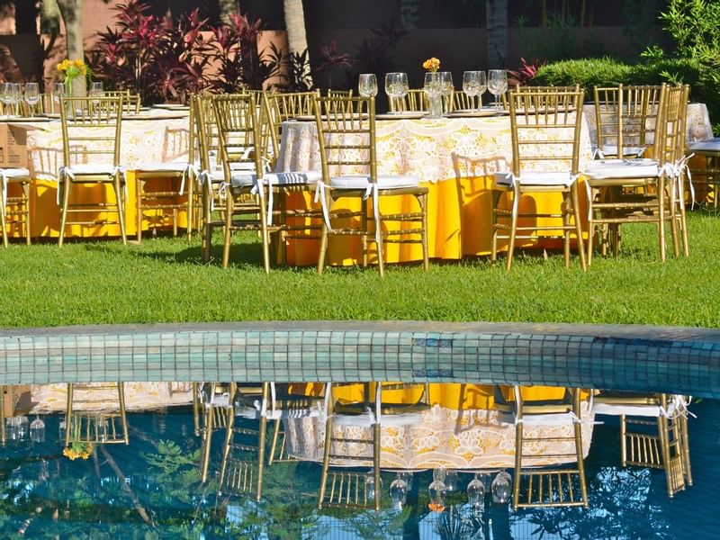 Tables arranged by the outdoor pool at Gamma Hotels