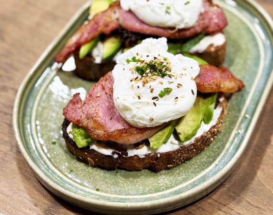 Poached egg with bacon and avocado on toast, served at Gott's Bar & Kitchen, The Met Hotel Leeds, England