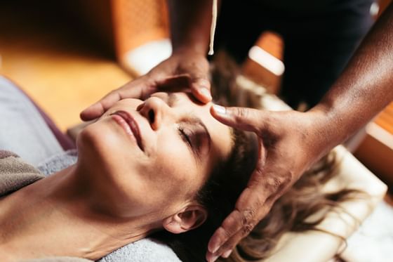 Close-up of a lady receiving a head massage at Liebes Rot Flueh