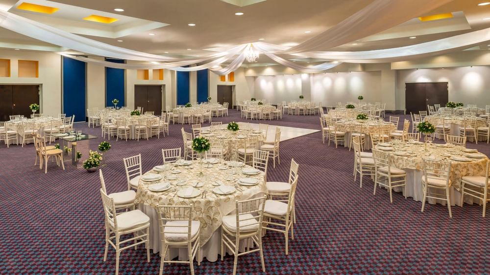 Salón Camino Real decorated for a gala with white draped ceilings and round dining tables at Camino Real Veracruz