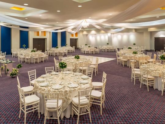 Salón Camino Real decorated for a gala with white draped ceilings and round dining tables at Camino Real Veracruz