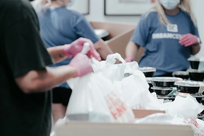 Volunteers of the hotel packing food into bags at Sofitel Brisbane Central