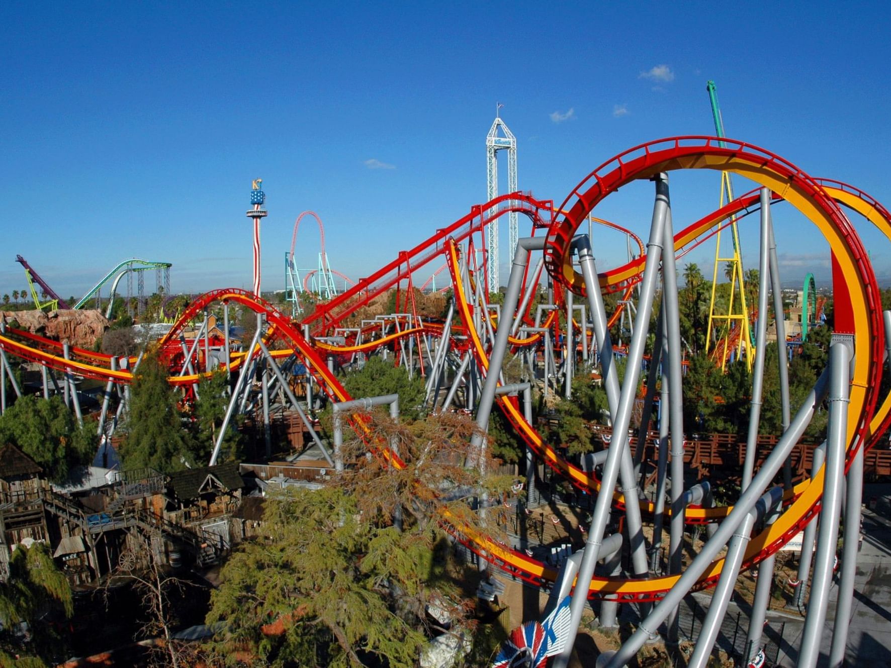 Knott's Berry Farm roller coasters with blue sky and trees.