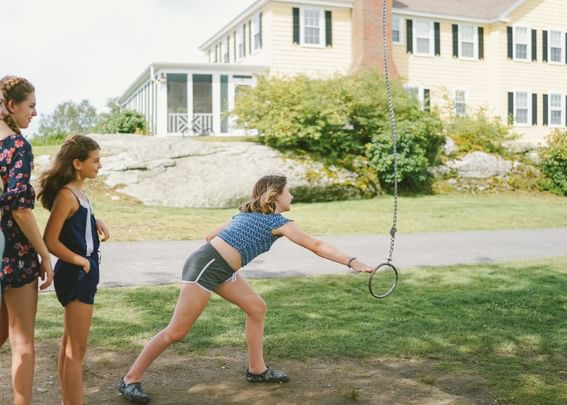 Girls playing with outdoor activities by the hotel at Sebasco Harbor Resort