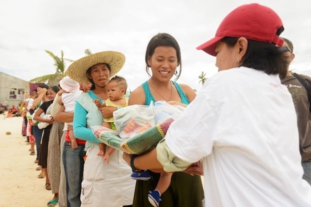 A queue of women holding babies.