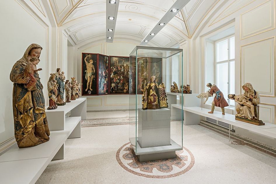 Exhibition room at the Dom Museum Vienna displaying religious sculptures and sacred artworks from different centuries.