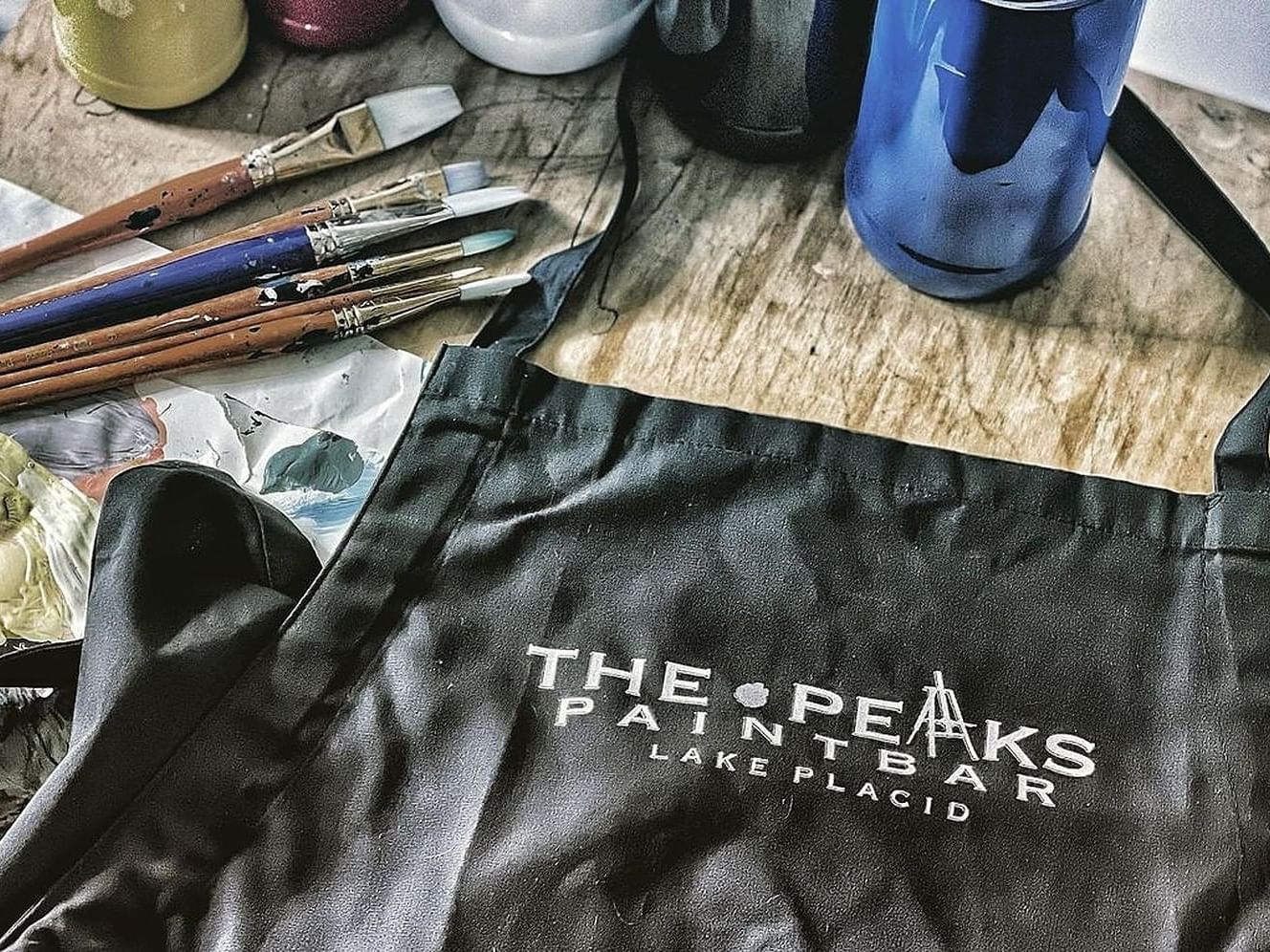 Paint brushes with tote bag on the wooden table at High Peaks Resort