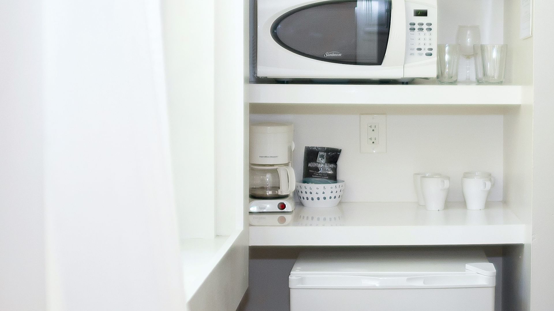 The Junior Deluxe room kitchen with a microwave at DOT Hotels