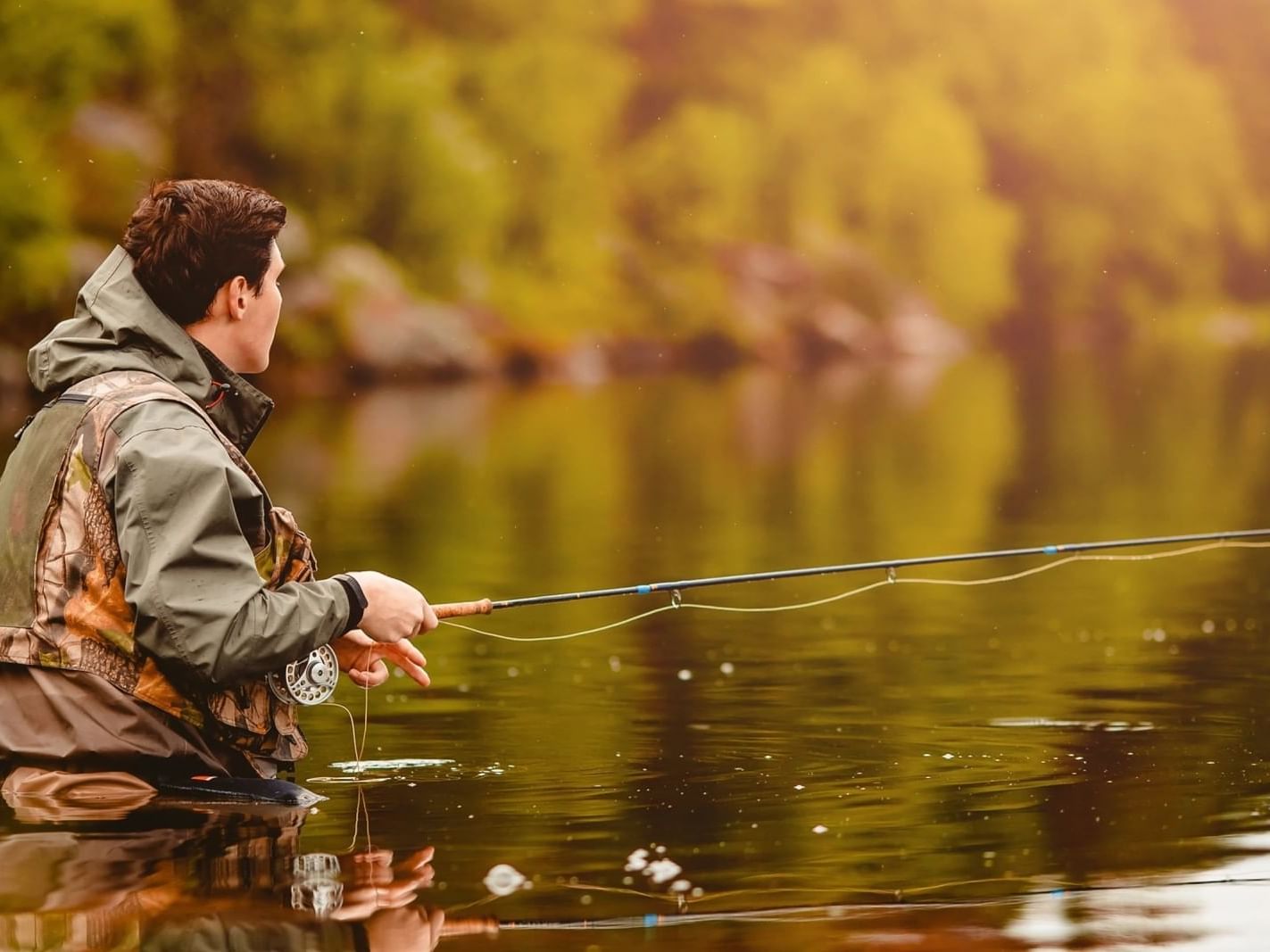 Man fishing with a rod at Brighton Park near South Branch Inn Romney