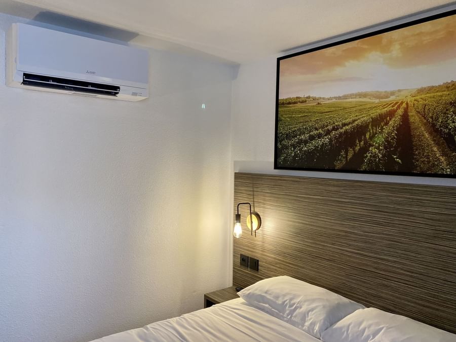 A/C room with nigh lamp at Angers South at The Originals Hotels
