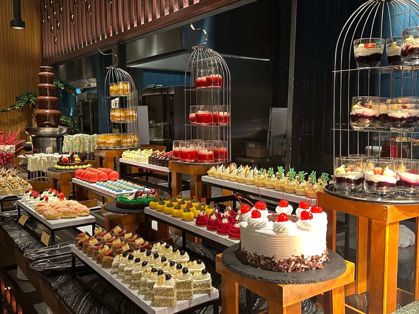 International Buffet Lunch & Dinner table featuring a variety of desserts at One World Hotel