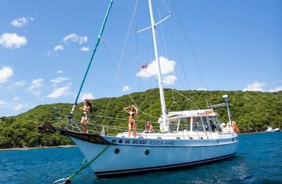 A sailboat sailing on the river near Villas Sol Beach Resort