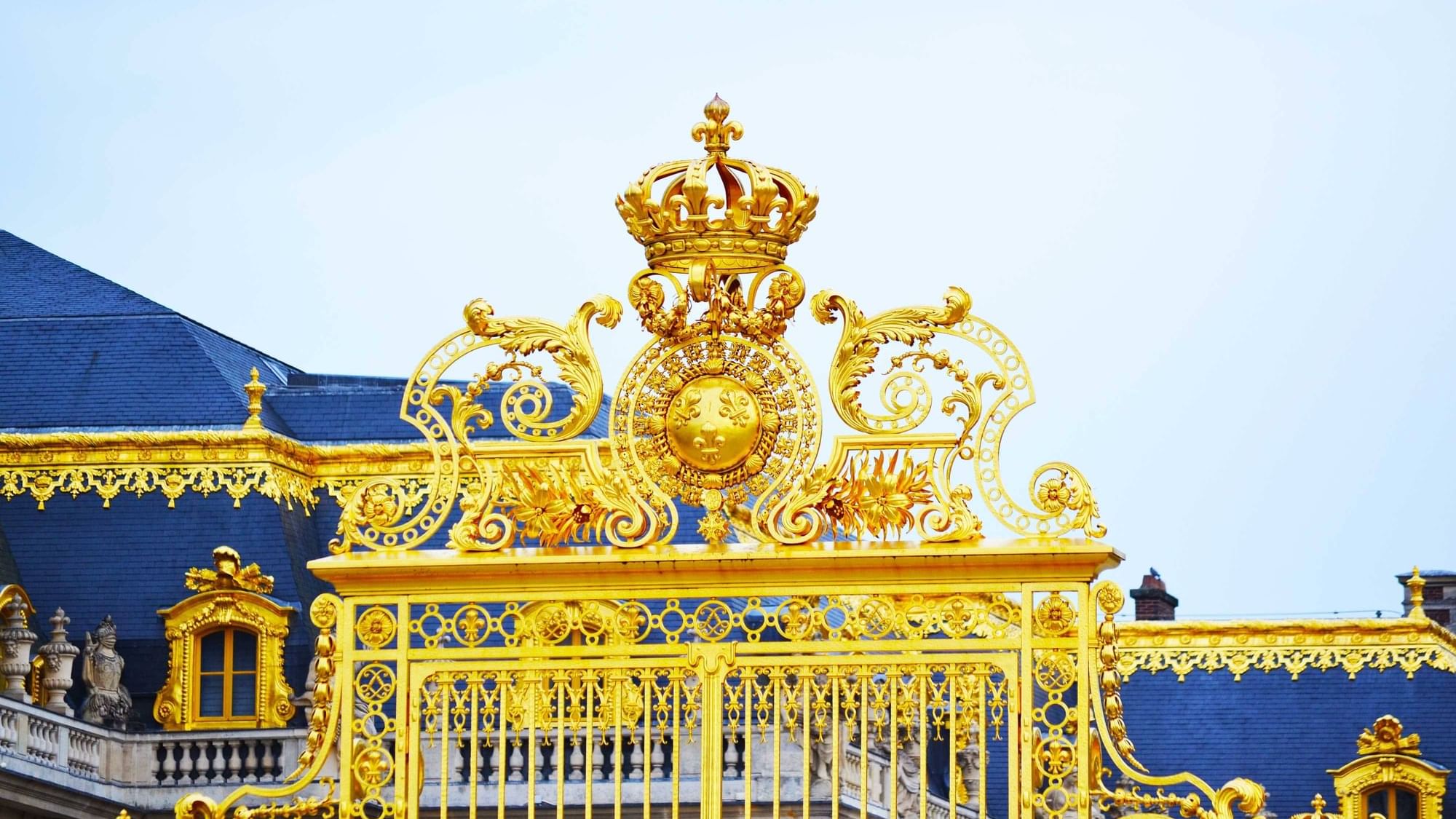 Golden grill gate of Versailles palace near Originals  Hotels