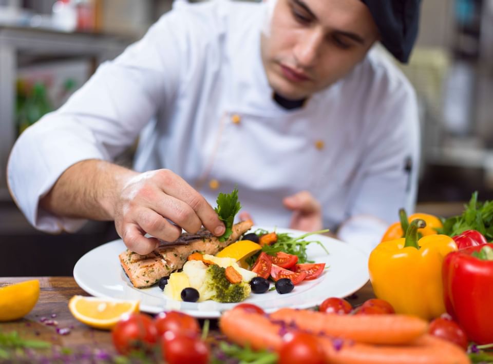 Chief garnishing a dish at Sunseeker Resort