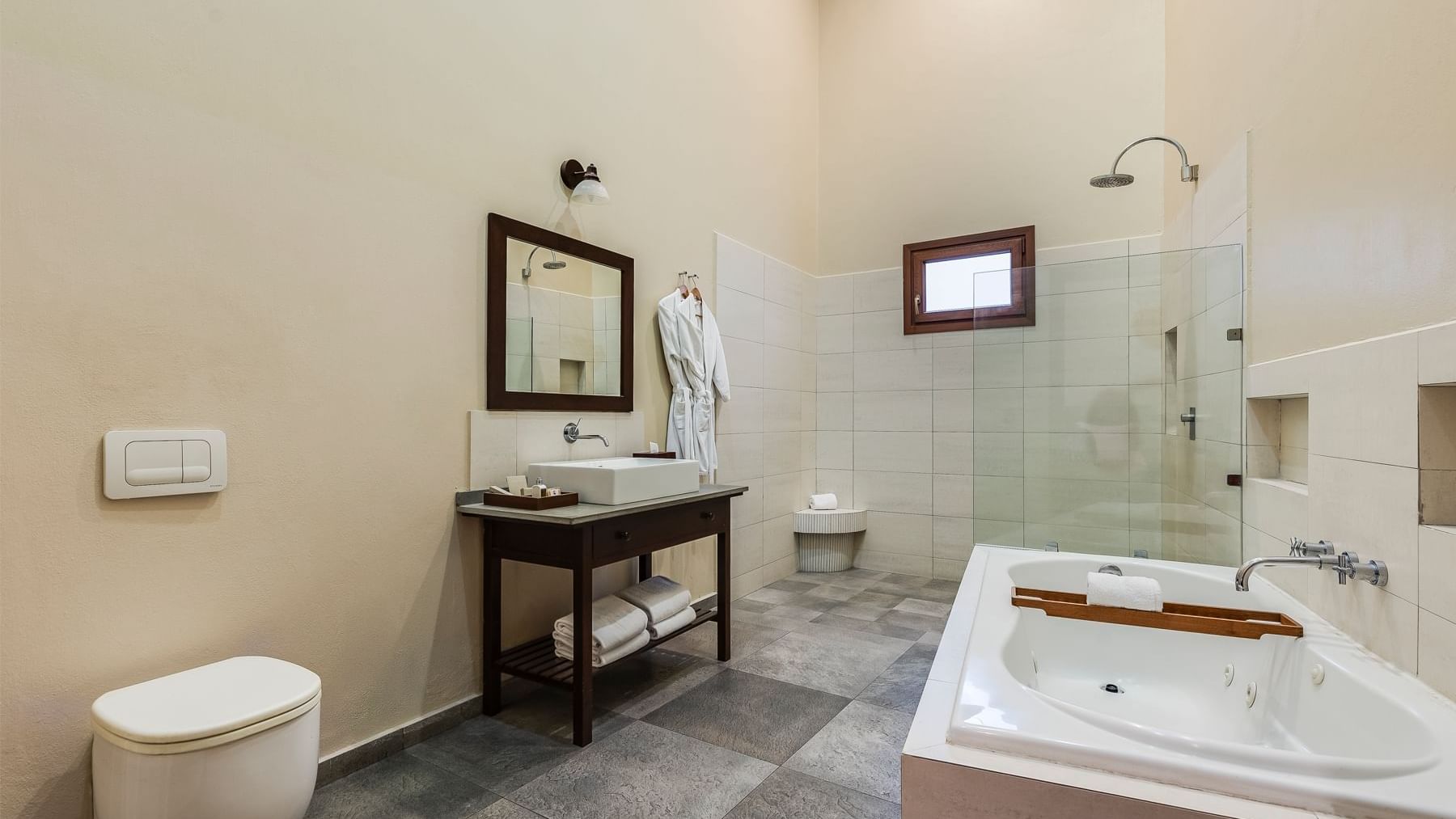 Spacious bathroom featuring a bathtub, shower, and vanity at Curamoria Collection