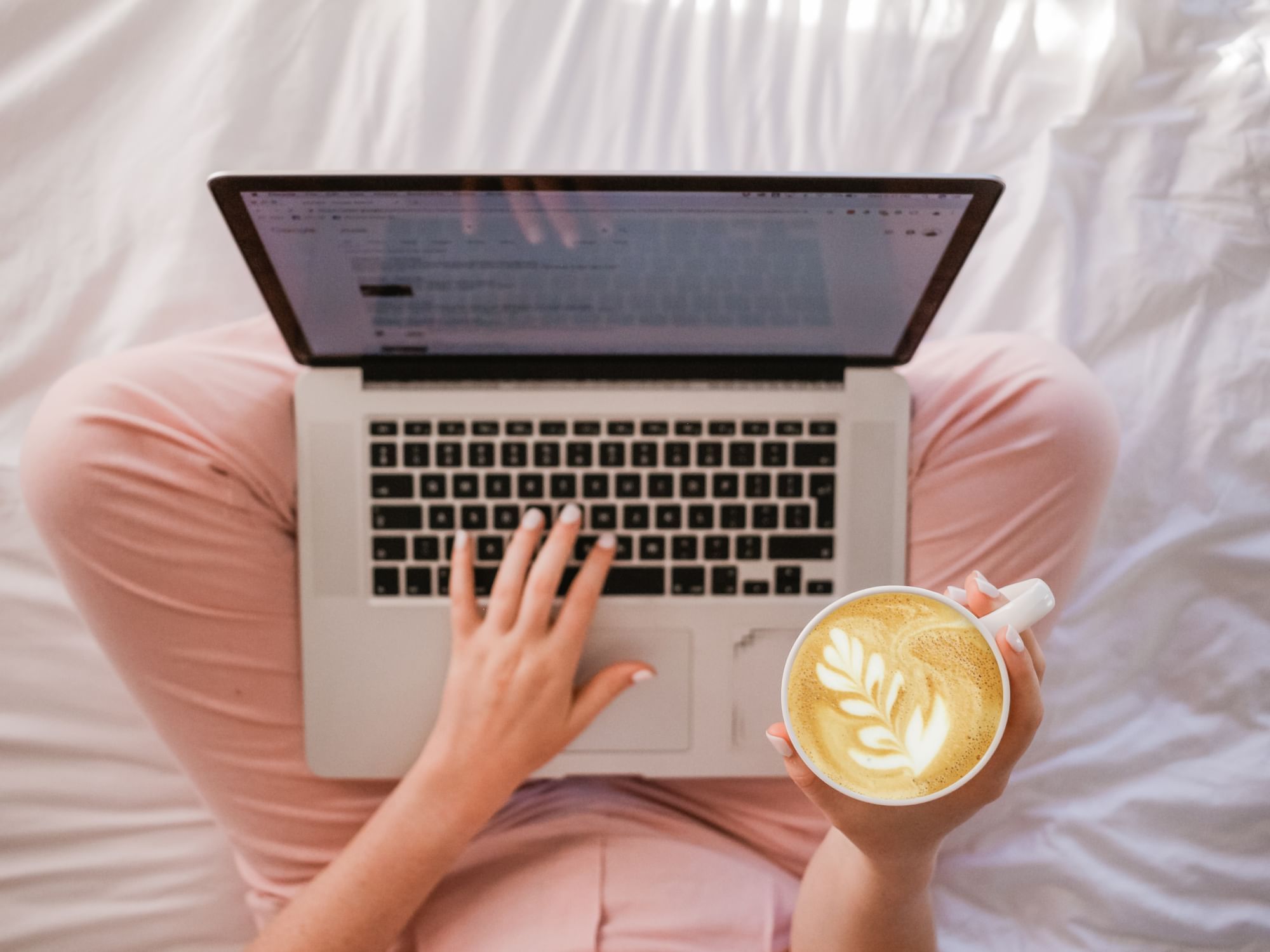 Woman working on laptop while having cappuccino at Henn Na Hotel New York