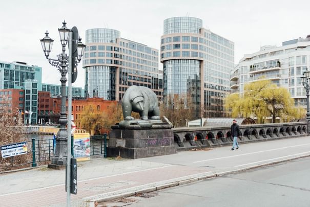 A statue of a bear on a bridge near the Hotel Berlin Berlin