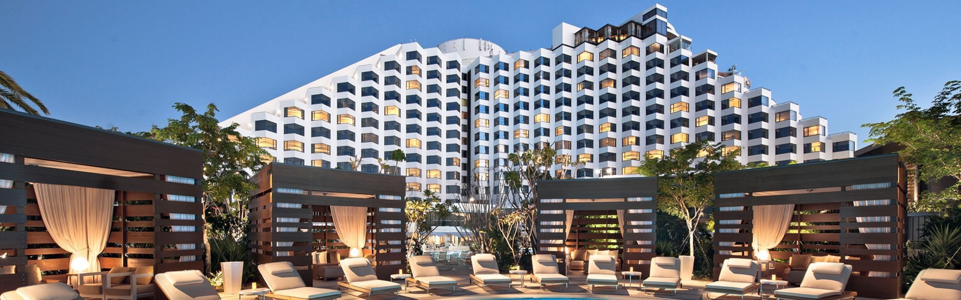 Exterior view of Crown Metropol Perth with pool beds and cabanas