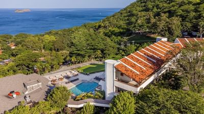 Aerial view of the Villas Sol Beach Resort around the sea and trees