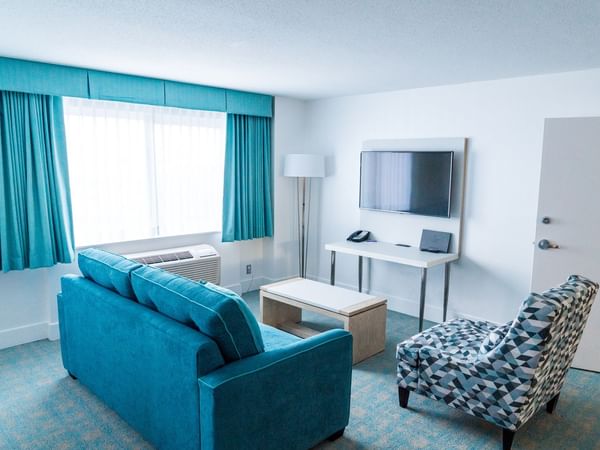 Sofa and TV in living area of hotel room