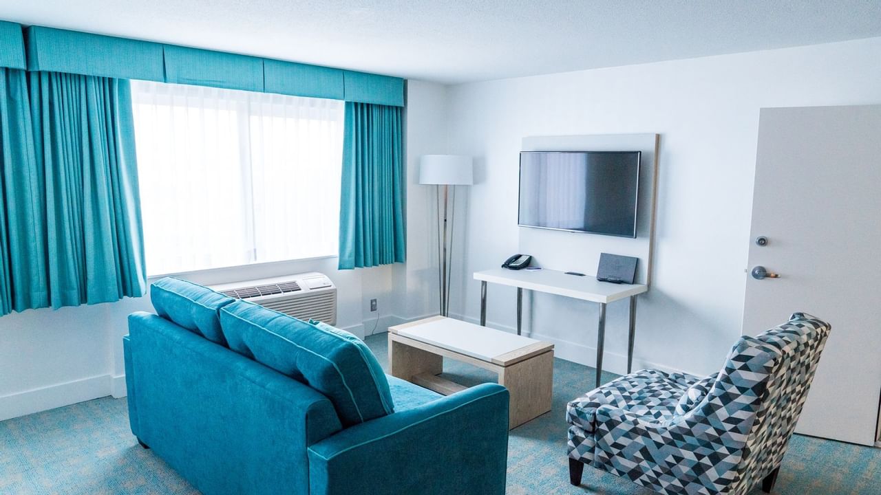 Sofa and TV in living area of hotel room