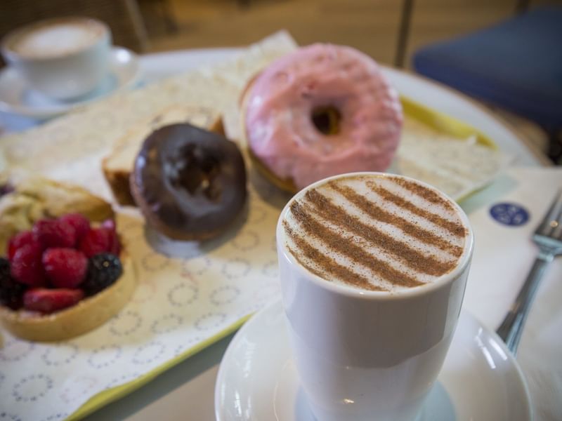 Donuts and a cup of coffee served by The Diplomat Beach Resort