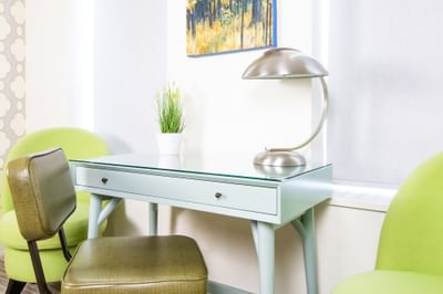 Work desk with lamp & chair in Queen Premiere Sunset at Retro Suites Hotel