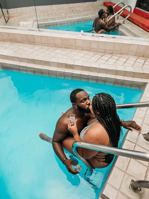Couple being romantic in the indoor swimming pool at Cove Pocono Resorts