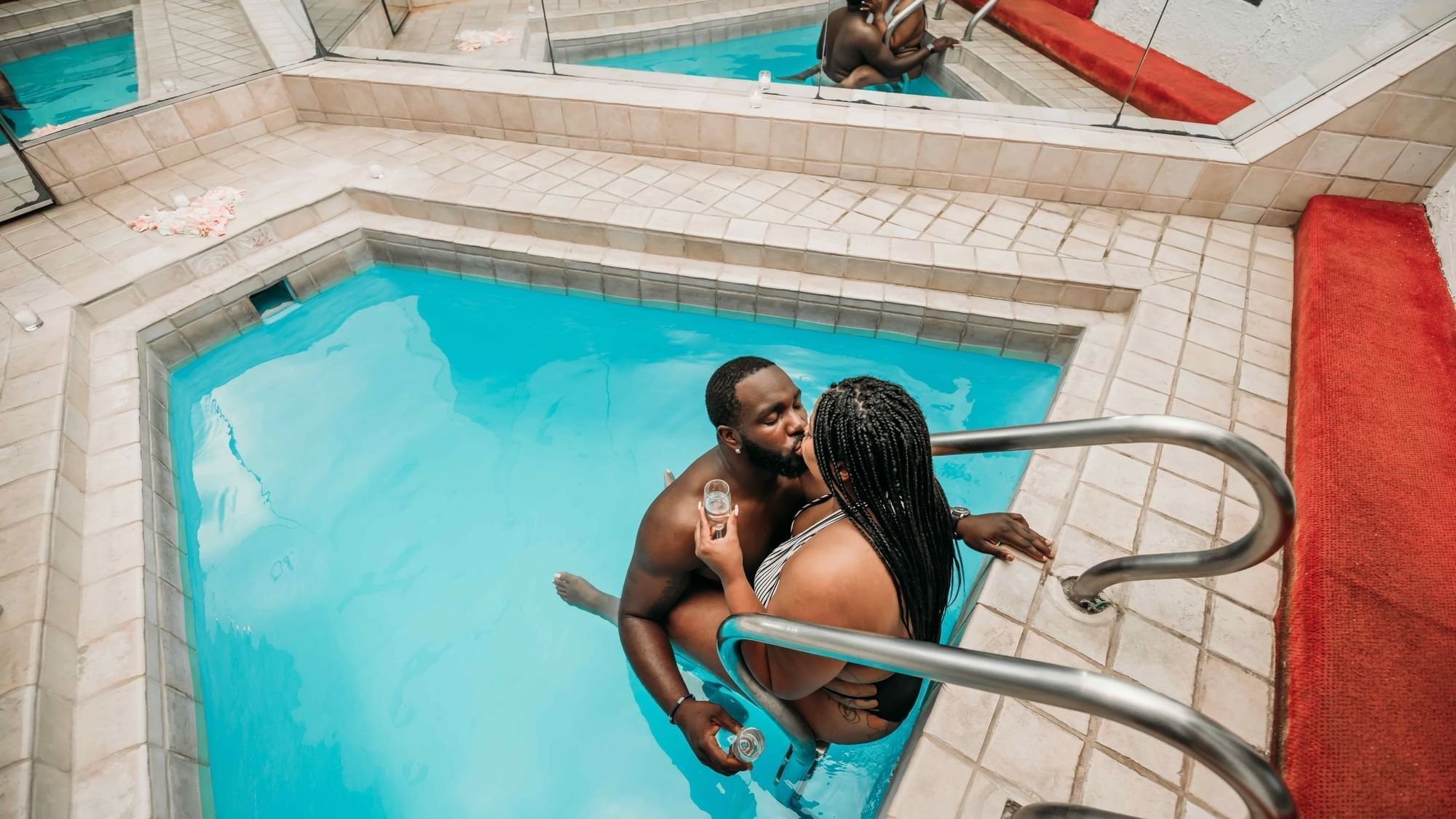 Couple being romantic in the indoor swimming pool at Cove Pocono Resorts