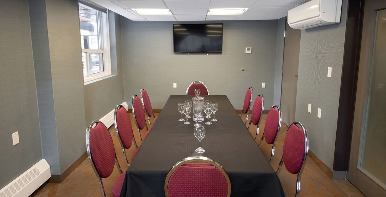 Coast Calgary Downtown Hotel & Suites by APA meeting room with chair, table, air condition, and TV