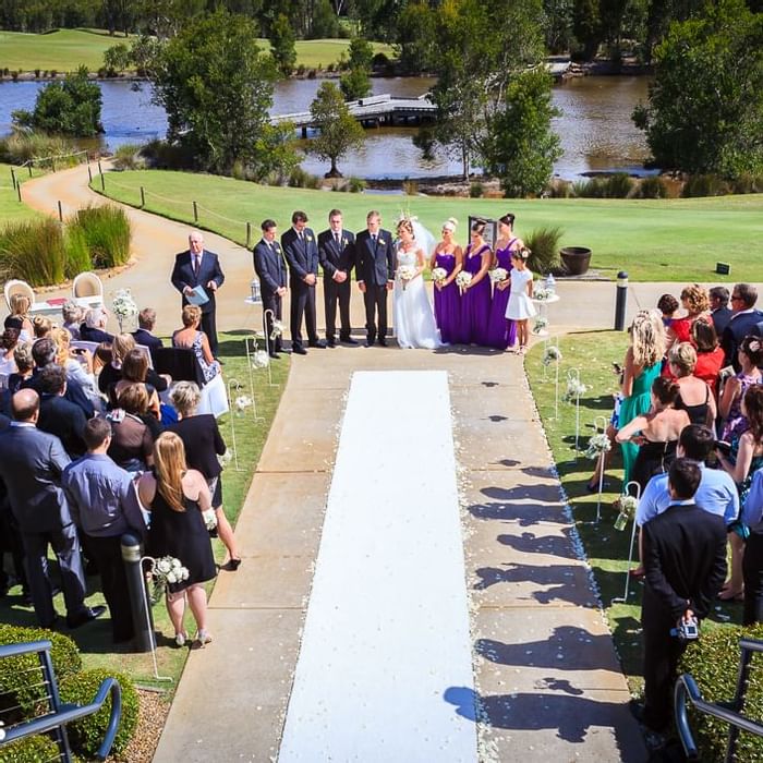 Wedding ceremony happening near the lake of Mercure Kooindah Waters