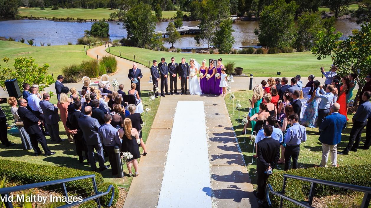 Wedding ceremony happening near the lake of Mercure Kooindah Waters