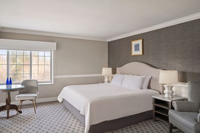 Cozy bed, table & chair in Madison Suite at The Madison Hotel