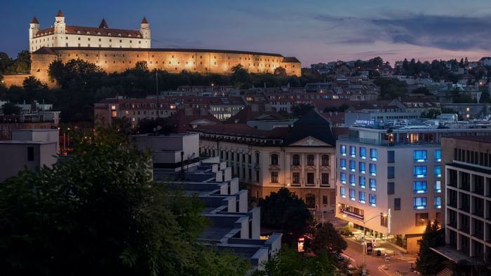 Distant high-angle view of Falkensteiner Hotel Bratislava at night