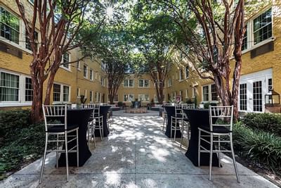 Tables and chairs set up in a courtyard area at Artmore Hotel